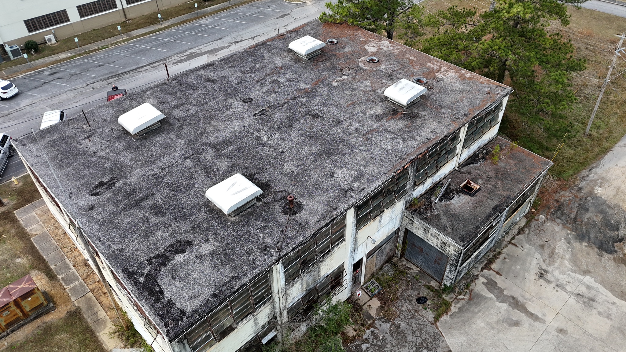 Crew installing Duro-Last PVC membrane and tapered insulation on commercial roof