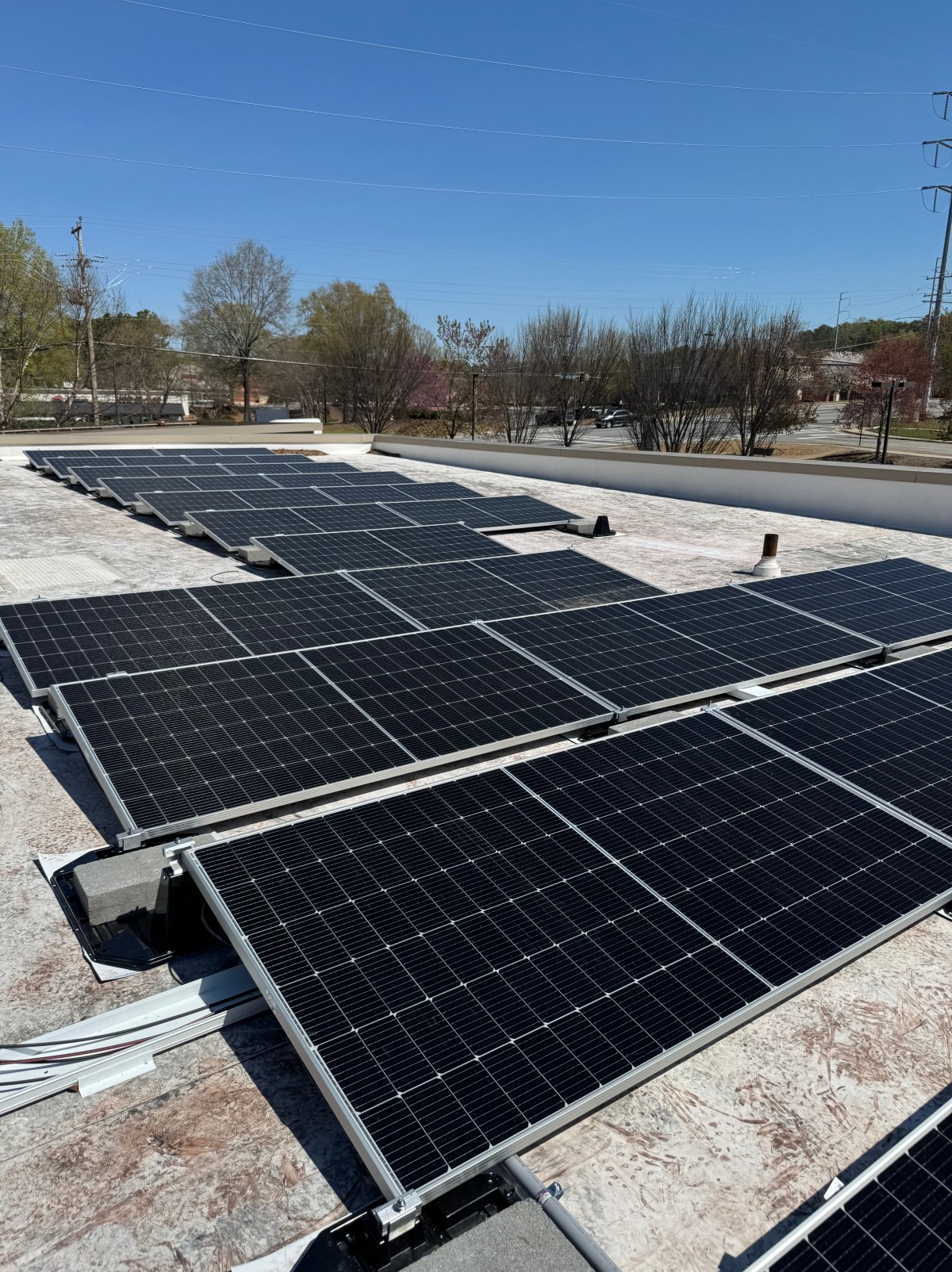 Solar panels installed on a roof by First Class Roofing