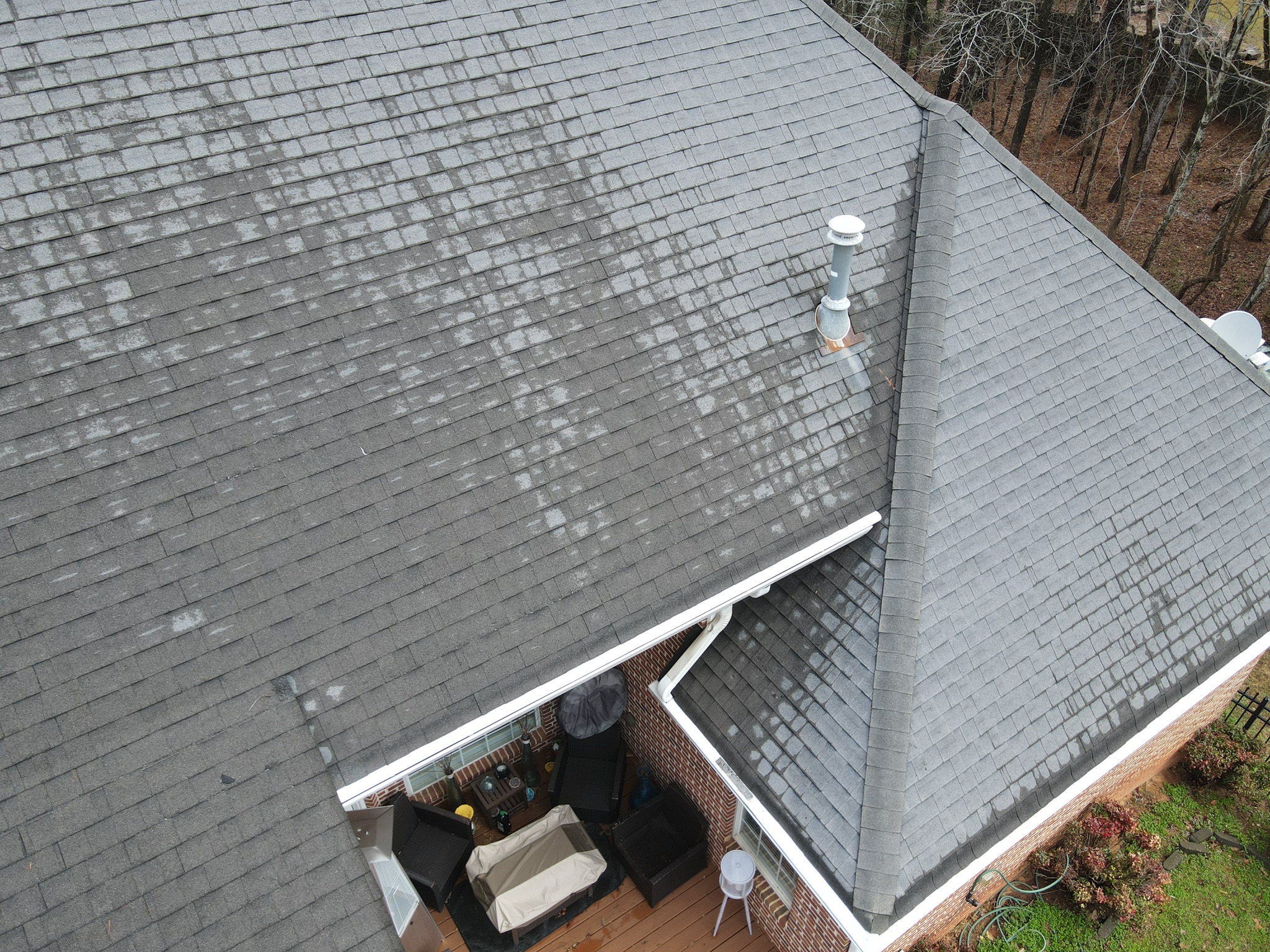 Aerial view of weathered tan shingles on Trussville Alabama home before hail damage roof replacement