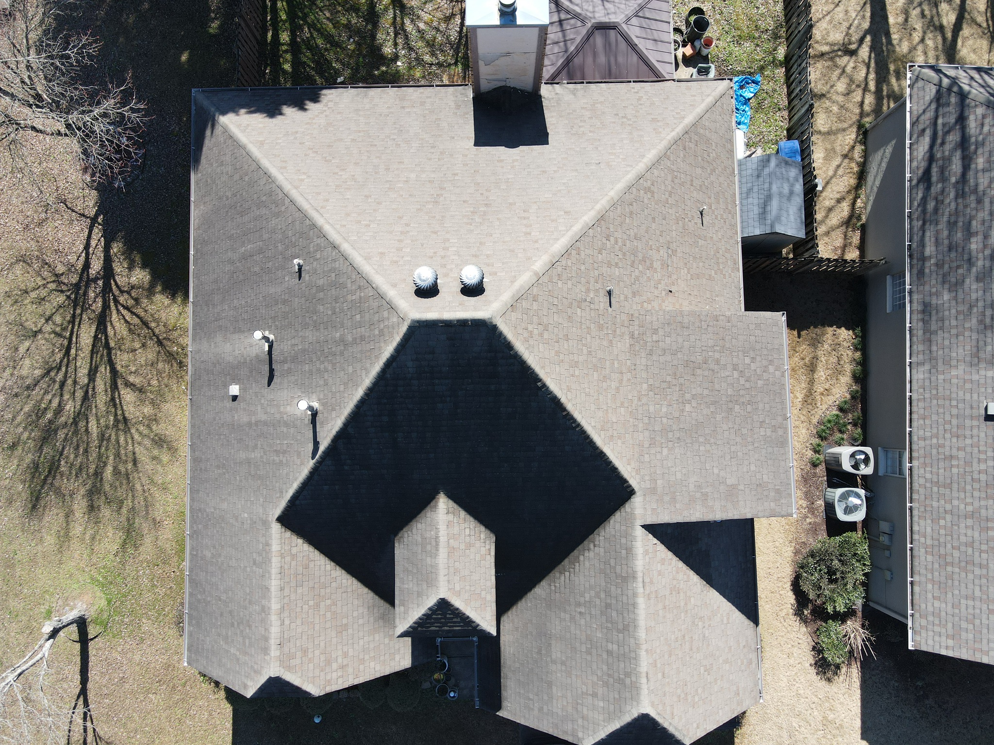 Aerial view of finished IKO Cambridge Dual Brown architectural shingle roof in Trussville, Alabama after hail damage replacement